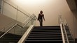 African American businesswoman walking down stairs
