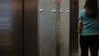 Mixed race businesswoman entering elevator