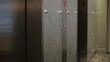 Mixed race businesswoman exiting elevator