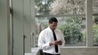 Black businessman text messaging on cell phone