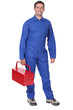 Man wearing blue overalls holding tool kit