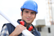 Tradesman carrying blueprints