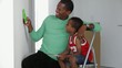 African American father with son checking paint colors