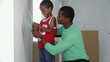 African American father with son checking paint colors