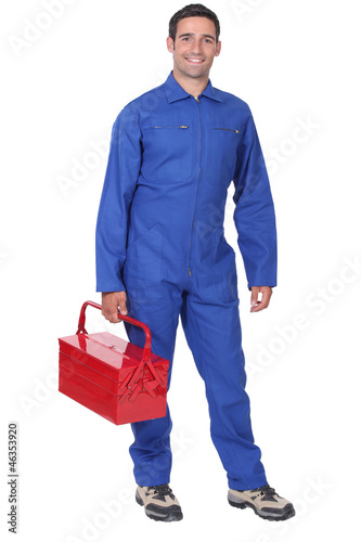 Photo: Man wearing blue overalls holding tool kit Man wearing blue overalls holding tool kit