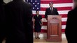 Political candidate at podium speaking
