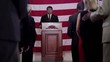 Hispanic political candidate giving speech at podium and talking to crowd