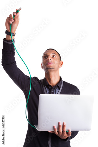 Photo: Young african american computer scientist plugin a ethernet cabl Young african american computer scientist plugin a ethernet cabl