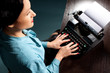Young woman typing with old typewriter
