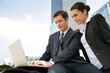 Photo: businessman and businesswoman working outdoors businessman and businesswoman working outdoors