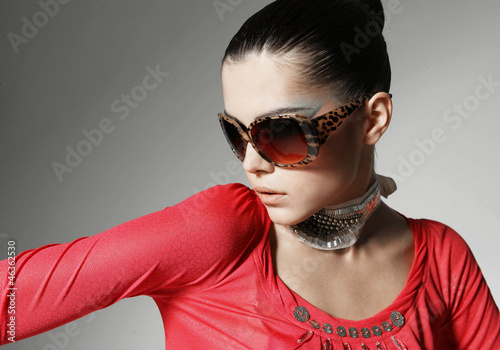 Photo: Head shot of woman wearing sunglasses against Head shot of woman wearing sunglasses against