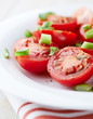 Cherry tomatoes with spring onion on a plate