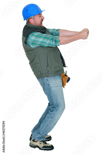 Photo: Construction worker pulling something Construction worker pulling something