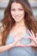 Photo: Young beautiful woman show love sign Young beautiful woman show love sign