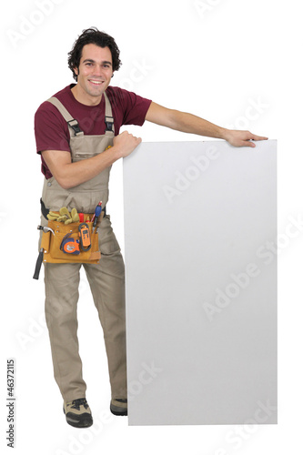 Photo: Carpenter stood with marketing board Carpenter stood with marketing board