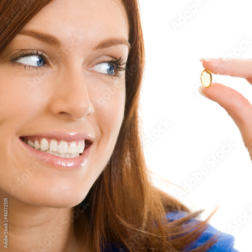 Photo: Cheerful woman with Omega 3 fish oil, over white Cheerful woman with Omega 3 fish oil, over white