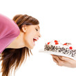 Cheerful woman eating pie, over white