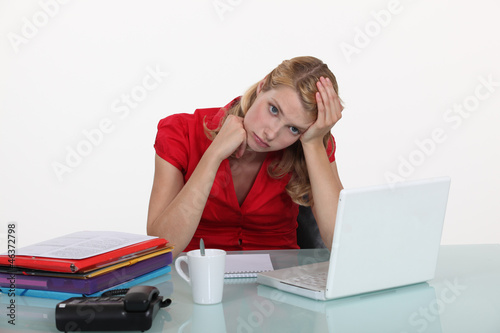 Photo: Woman bored at work Woman bored at work