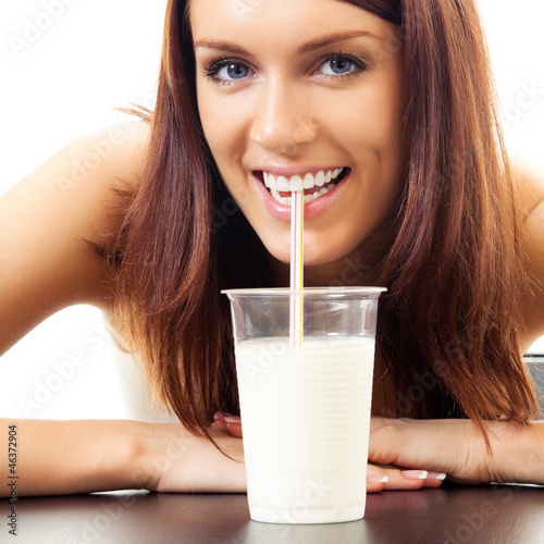 Photo: Beautiful woman drinking milk, over white Beautiful woman drinking milk, over white