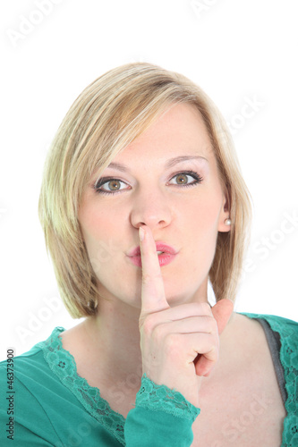 Photo: Woman requesting quiet with hushing gesture Woman requesting quiet with hushing gesture