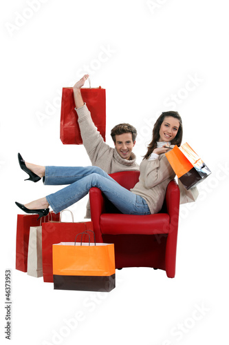 Photo: Couple posing with their shopping bags Couple posing with their shopping bags