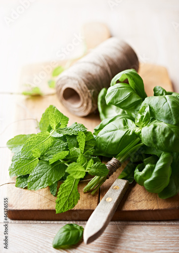 Photo: Fresh herbs on wooden kitchen board Fresh herbs on wooden kitchen board
