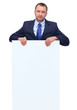 Portrait of happy business man showing blank signboard
