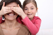 daughter putting her hands before mother's eyes
