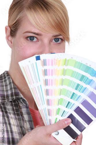 Photo: Woman choosing color of paint Woman choosing color of paint