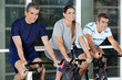 Men And Woman On Exercise Bikes