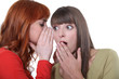 Woman whispering to her friend
