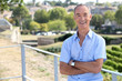 Senior man leaning against railing