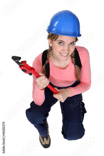 Photo: Woman holding wrench Woman holding wrench