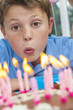 Boy Child Blowing Out Birthday Cake Candles