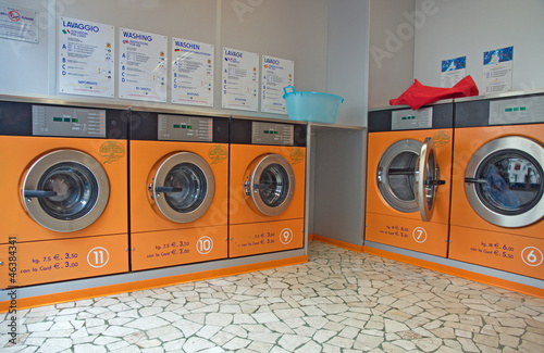 Photo: automatic washing machines in a laundromat automatic washing machines in a laundromat