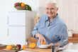 An old lady pressing oranges.