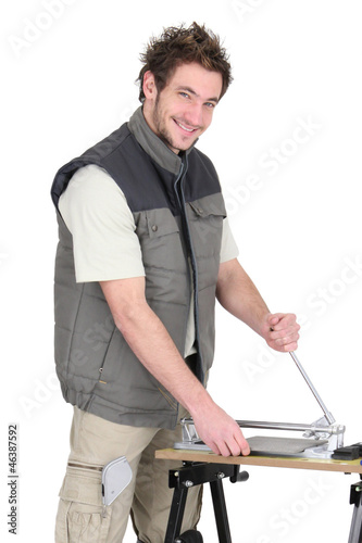 Photo: Tiler using workbench Tiler using workbench