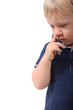 Little boy picking his nose