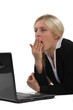 Woman yawning in front of computer