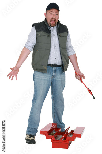 Photo: Annoyed tradesman looking for a lost tool Annoyed tradesman looking for a lost tool