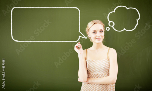Photo: portrait of young teacher near blackboard portrait of young teacher near blackboard