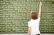 Photo: Scoolgirl standing near blackboard Scoolgirl standing near blackboard