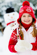 Winter fun , snowman, happy kid playing at winter time