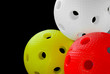 Photo: Three floorball balls isolated on a black background Three floorball balls isolated on a black background
