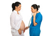 Photo: Doctor examine pregnant woman tummy Doctor examine pregnant woman tummy