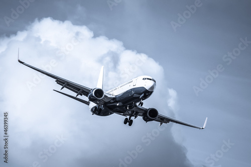 Photo: cool toned passenger jet on landing approach cool toned passenger jet on landing approach