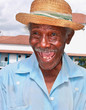 Photo: Old sympathetic cuban man with straw hat make a funny face, Cuba Old sympathetic cuban man with straw hat make a funny face, Cuba