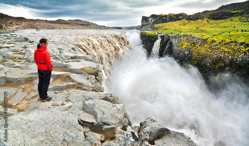 Photo: Woman standing near famous Dettifoss waterfall in Iceland Woman standing near famous Dettifoss waterfall in Iceland