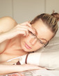 Woman confined to bed lying reading