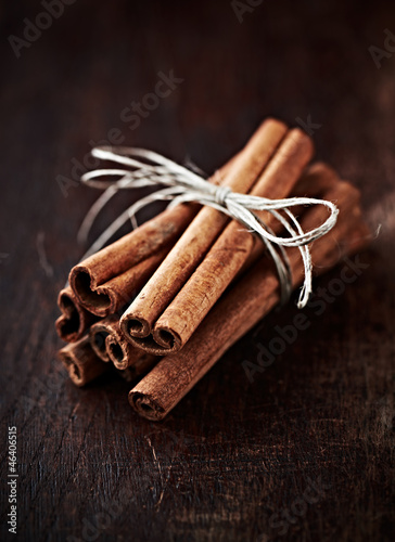 Photo: Cinnamon sticks on dark wooden background Cinnamon sticks on dark wooden background